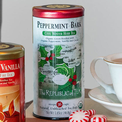peppermint bark tea canister displayed next to a tea cup and saucer and peppermints