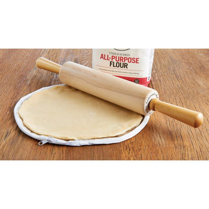the 11 inch pie crust maker displayed with pie crust a rolling pin bag of flower on a wooden surface