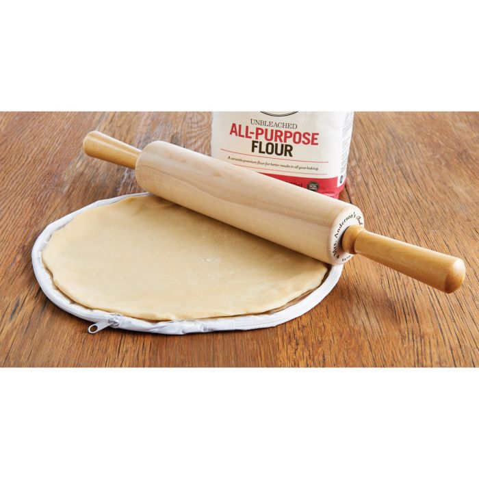the 14 inch pie crust maker displayed with a rolling pin bag of flower on a wood surface