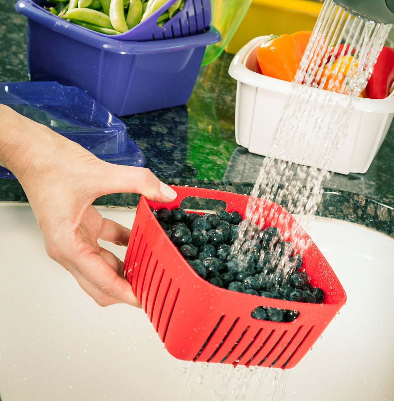 illustration of a berry box filled with blueberries being rinsed in a sink