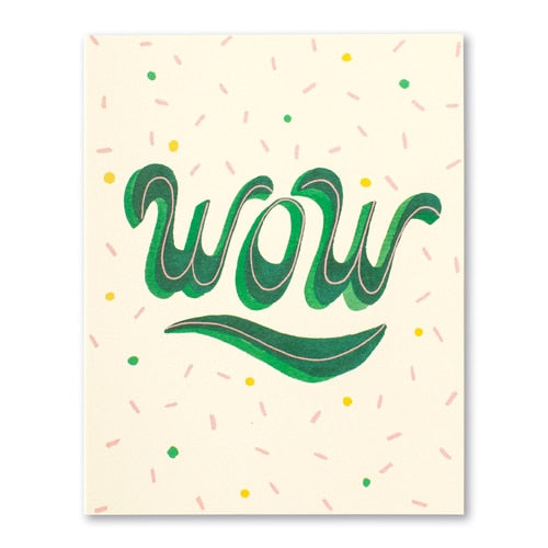 front of card is cream with confetti and front text bold in green
