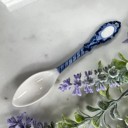 blue and white spoon with twist design on handle.