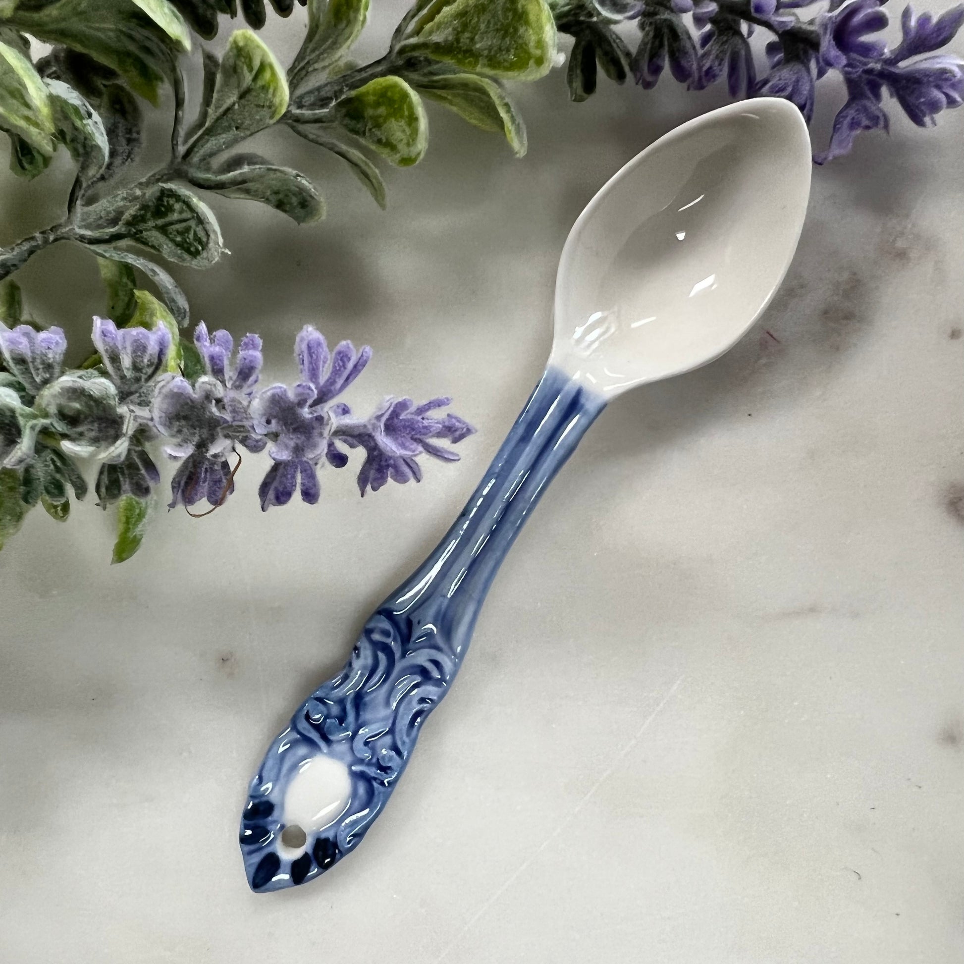 blue and white spoon with ornate pattern on handle.
