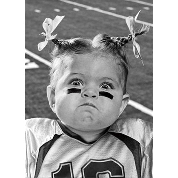 front of card is photograph of a girl in pigtails wearing a football jersey and black marks under her eyes