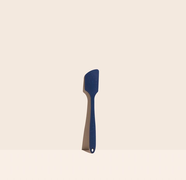 speckled navy starry night mini spatula displayed on a light pink background