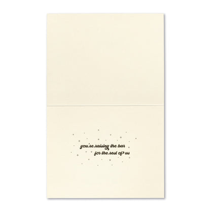 inside card is cream with inside text in black with stars