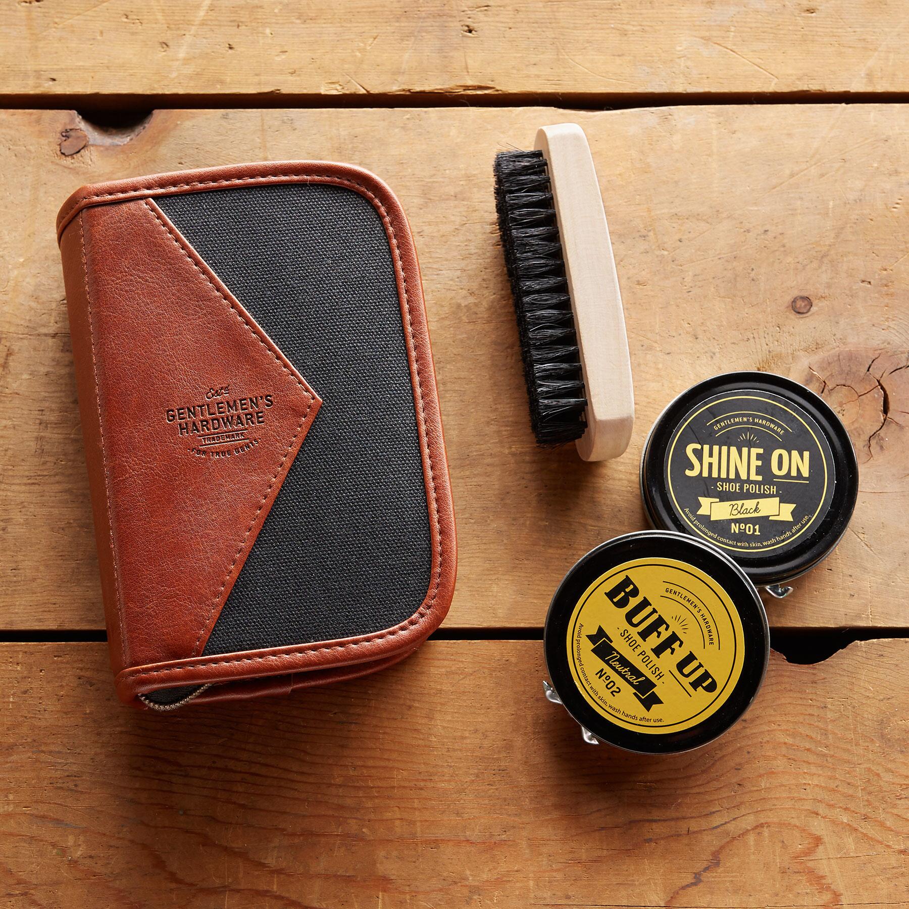 the shoe shine kit displayed beside the case on wood planks