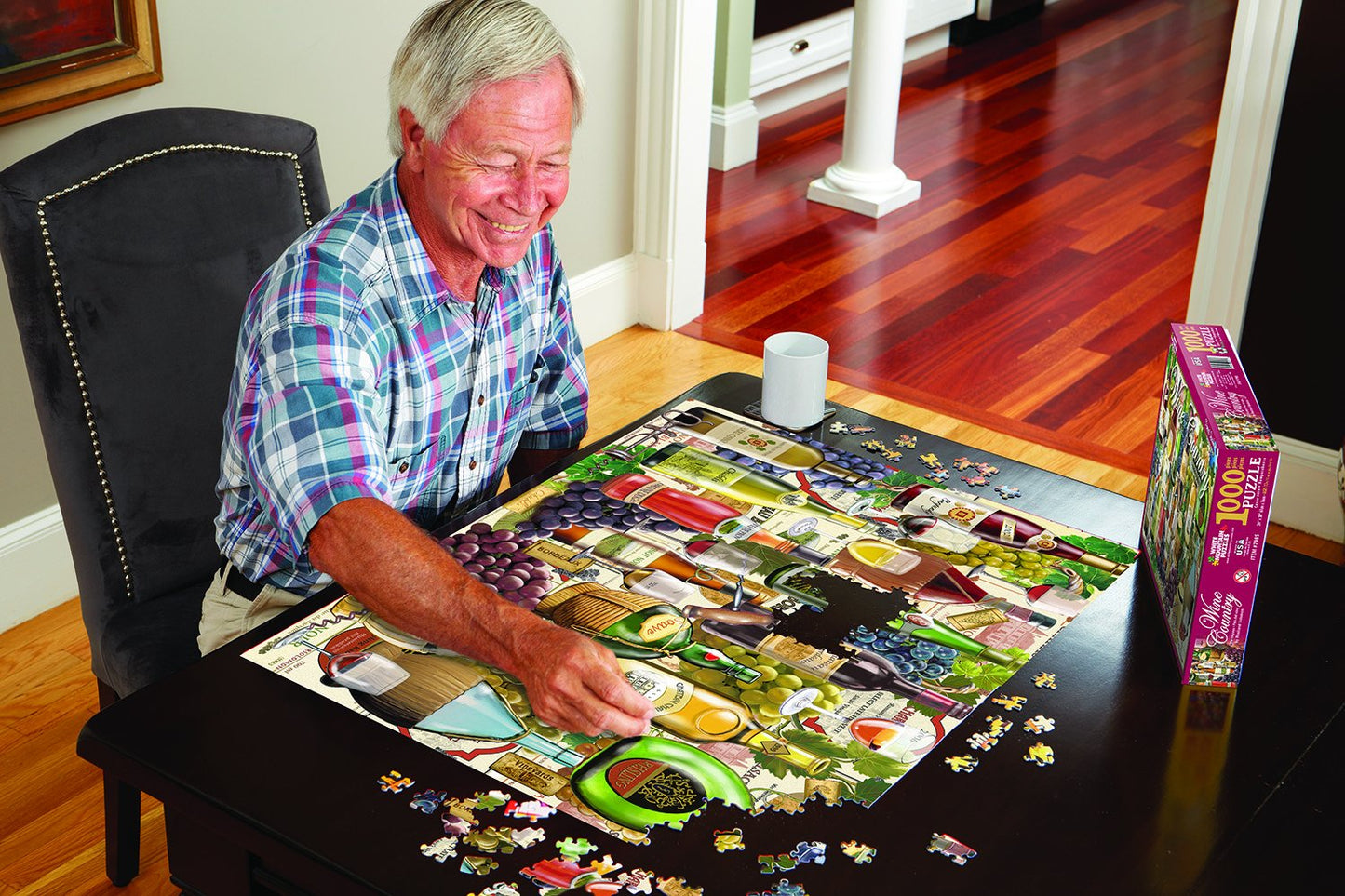 picture of a gentleman sitting at a dining table working on a puzzle