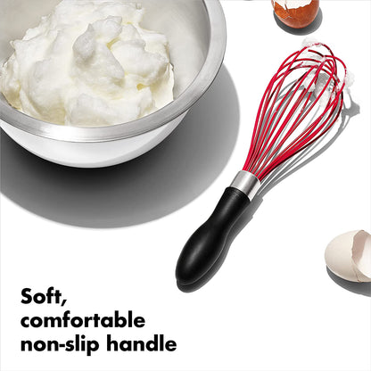 whisk on counter next to bowl and egg shells with text "soft, comfortable non-slip handle".