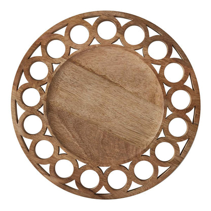 wooden charger with cuy out circles on white background.