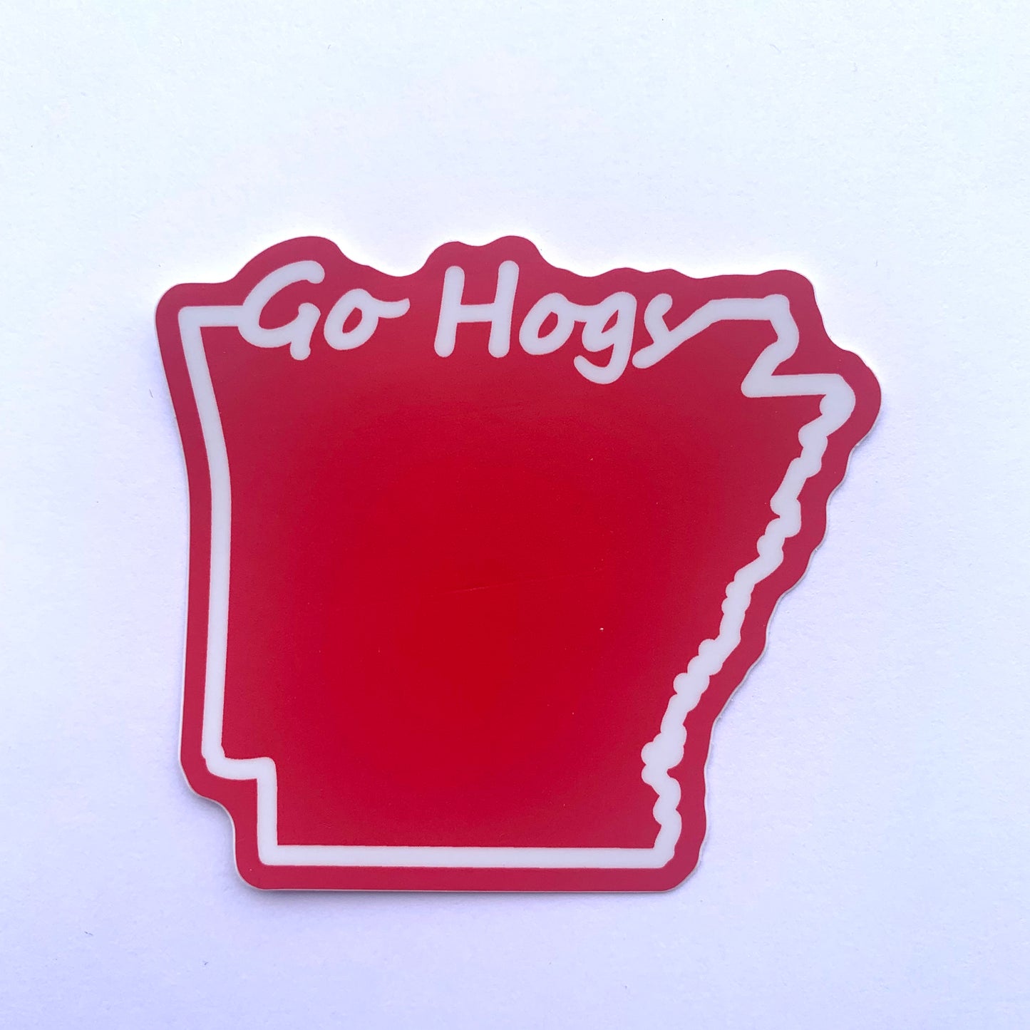 go hogs sticker is red with white outline of the state of arkansas on a white background