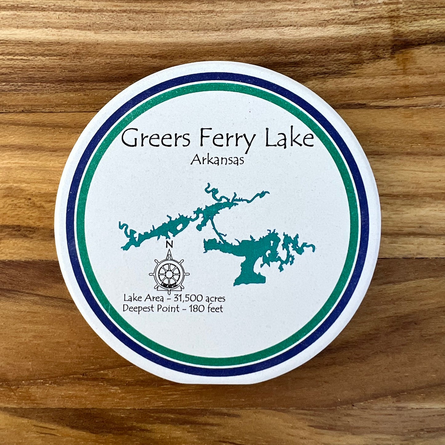 white round coaster with map of greers ferry printed on it.