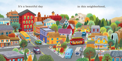 inside view of the book has illustration of the town with buses, cars, trolley, and text