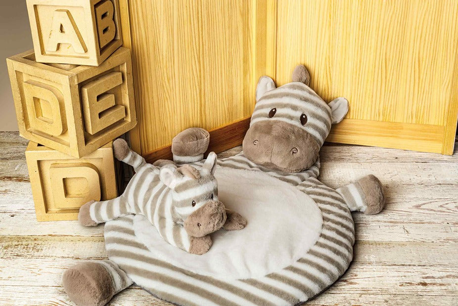 sebra mat in child's room with a zebra toy and a stack of large blocks.