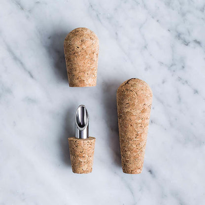 a set of two-in-one cork and pours on a marble surface