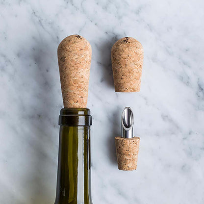 one cork and pour in a wine bottle and one laying on a marble surface