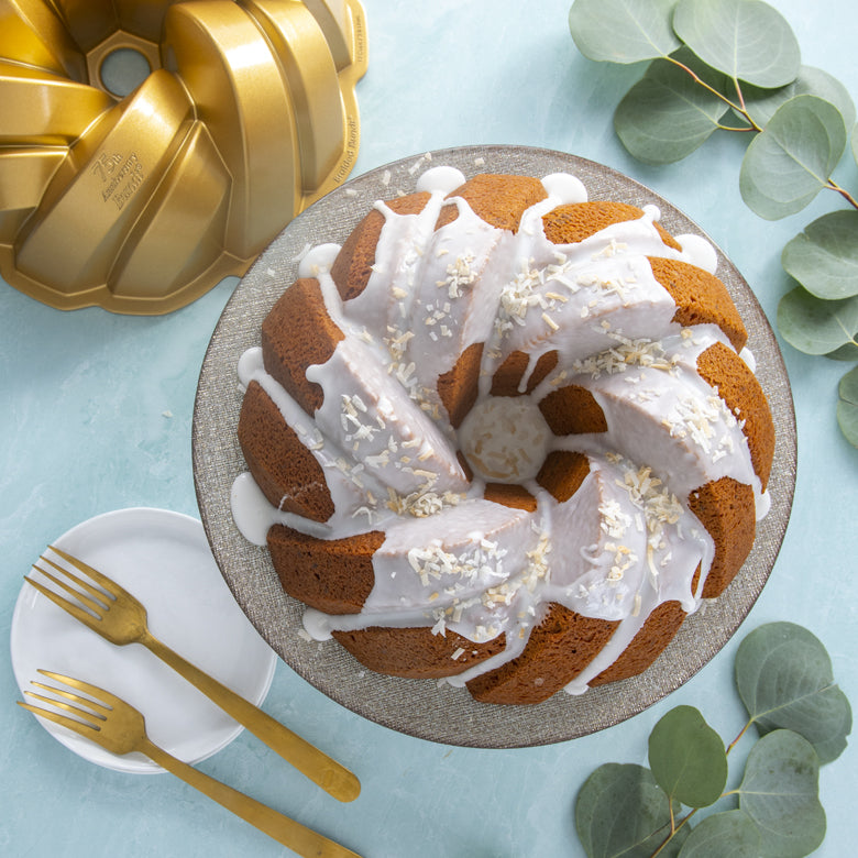top view of iced bundt cake with coconut toppings.