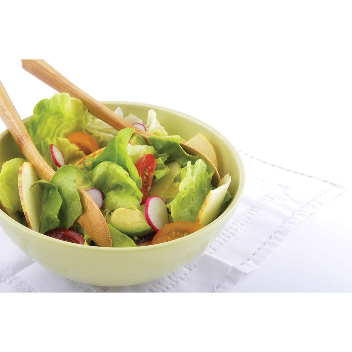 two 12 inch bamboo spoons displayed in a bowl of mixed salad on a white background