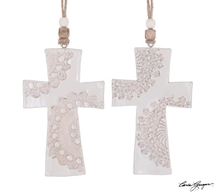 two lace imprinted crosses on a white background.
