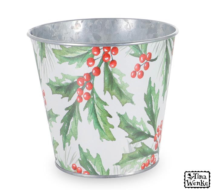 galvanized bucket with white exterior that has green holly leaves and red berries printed on it.