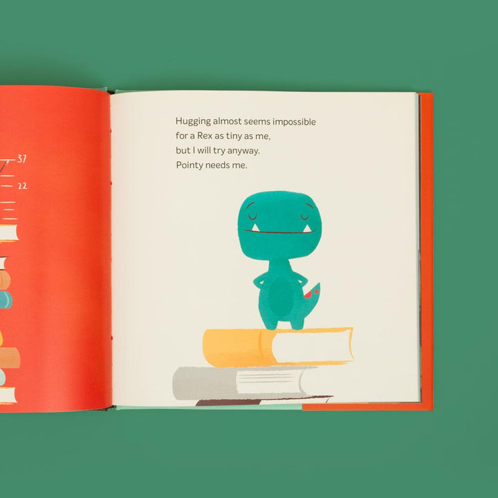 open book showing page with graphic of tiny t-rex standing on stack of books and text.