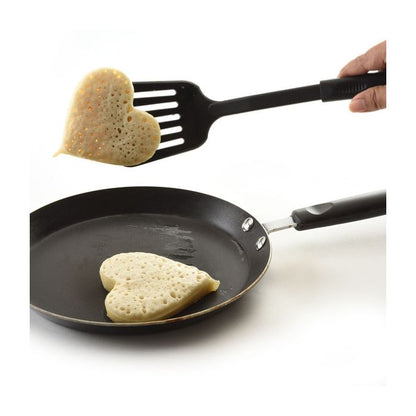 spatula removing heart shaped pancake from pan.