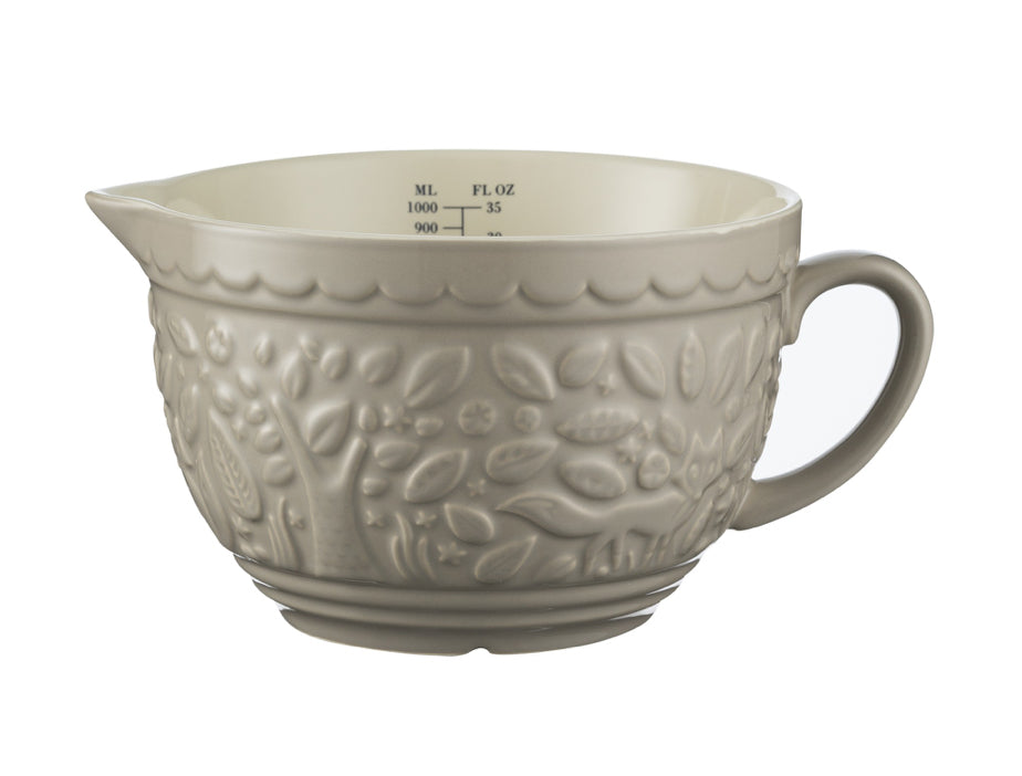 ceramic measuring bowl with handle and pouring spout on white background.