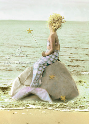 front of card is a photograph of a little girl dressed as a mermaid sitting on a rock by the ocean