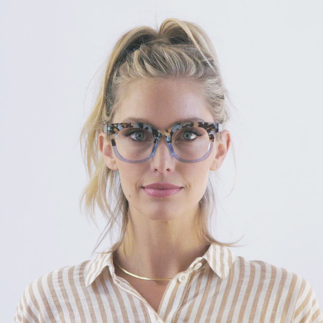 video of a woman modeling the blue quartz and blue glasses and turning her head to show both sides against a white background