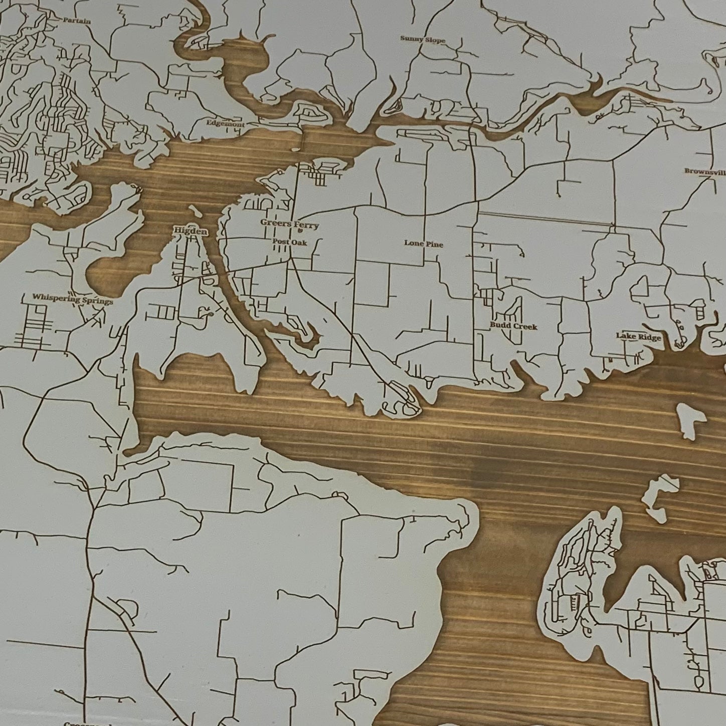 close up view of the burnt wood map of greers ferry in grey