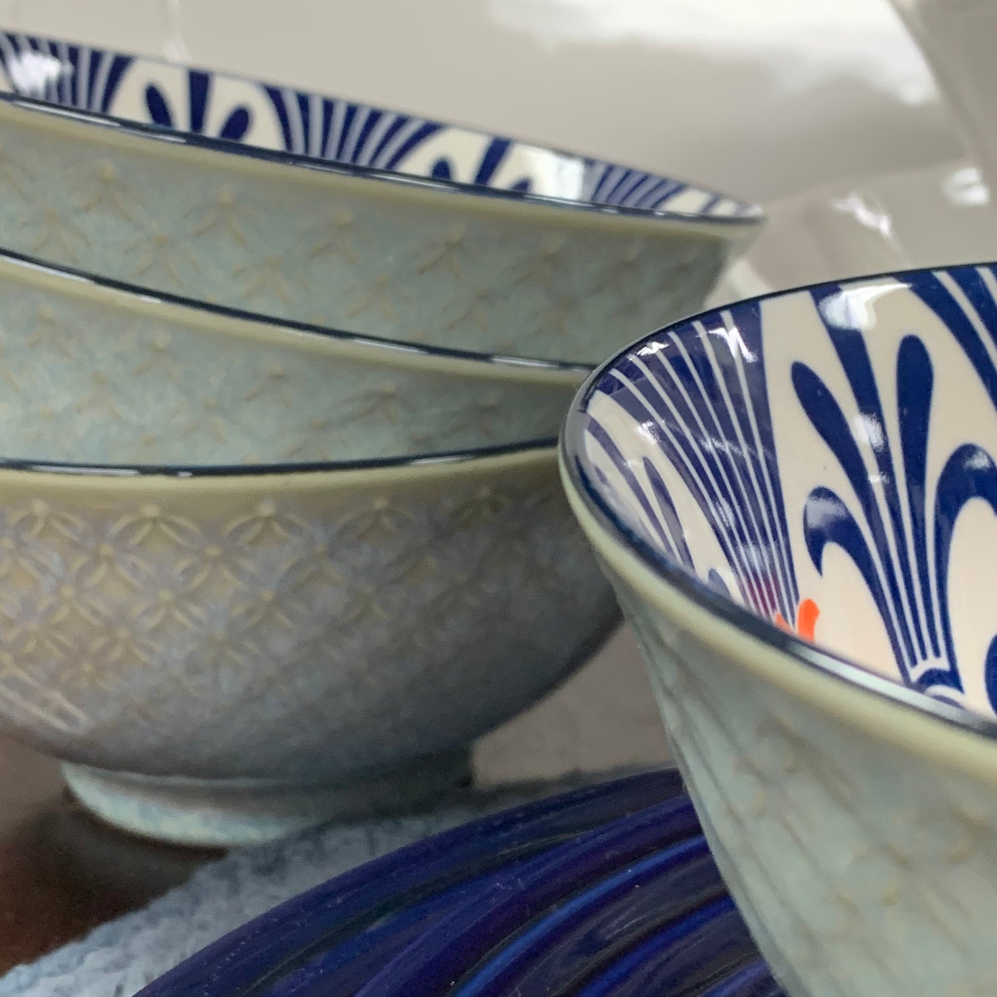 four nora bowls displayed with on a table with plates and charger
