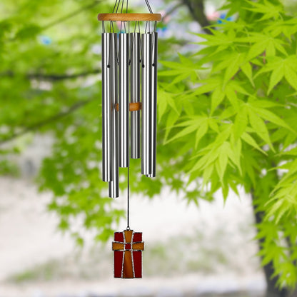 chime hanging from tree with leafy background.