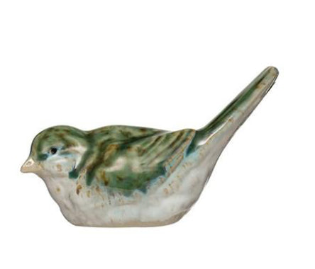 green and white ceramic bird with tail up on a white background.