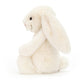 side view of the cream bashful bunny on a white background