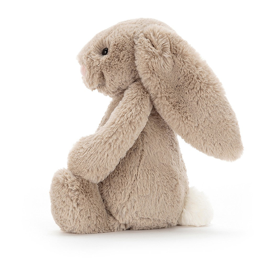 side view of the beige bashful bunny on a white background