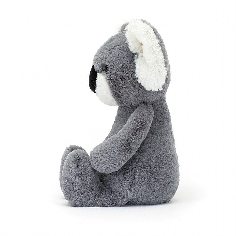 side view of this gray bashful koala plush toy displayed on a white background