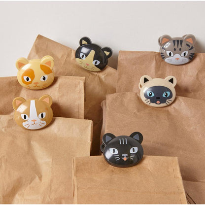 six brown bags with cat bag clips on each one against a white background