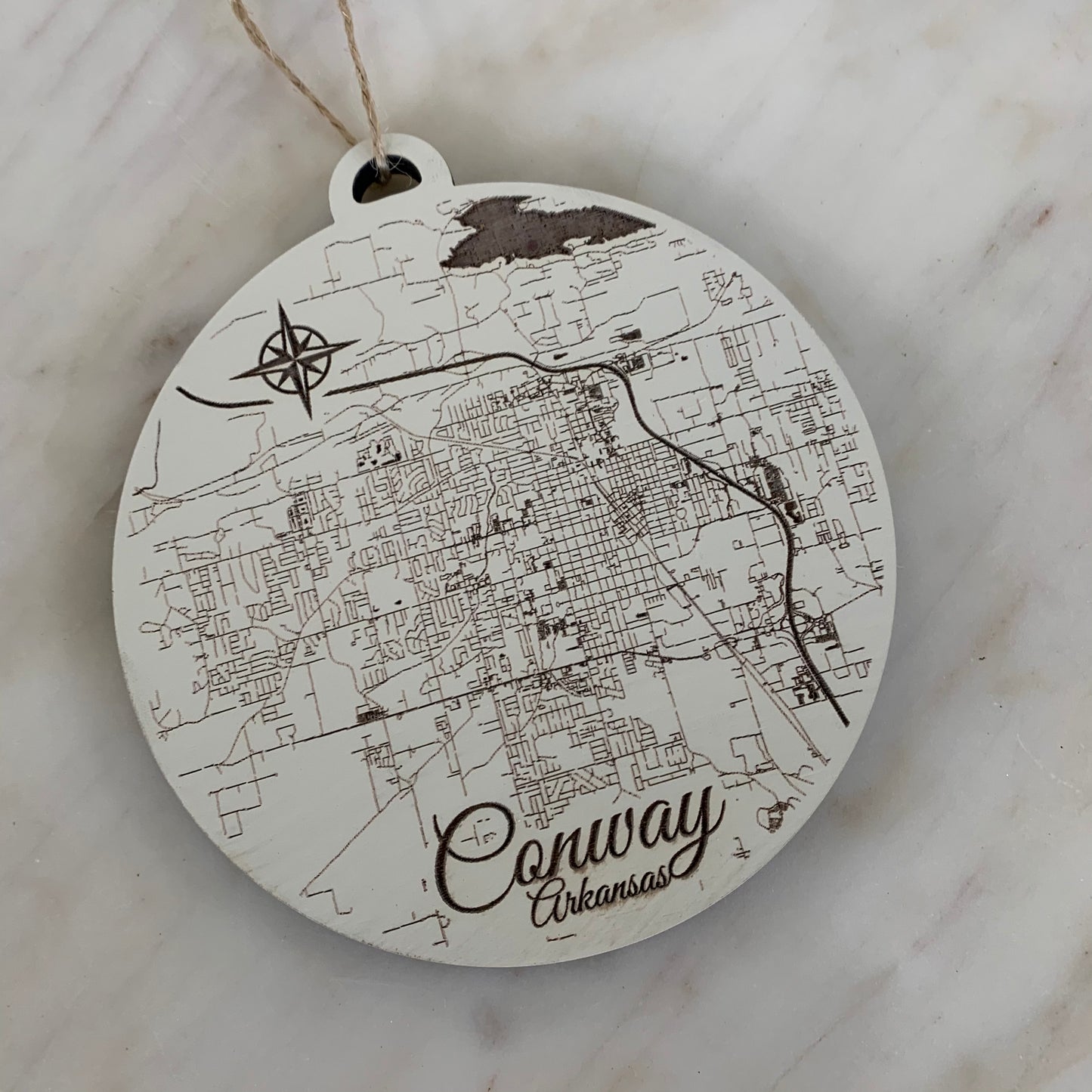 the burnt wood map ornament of conway on a white background