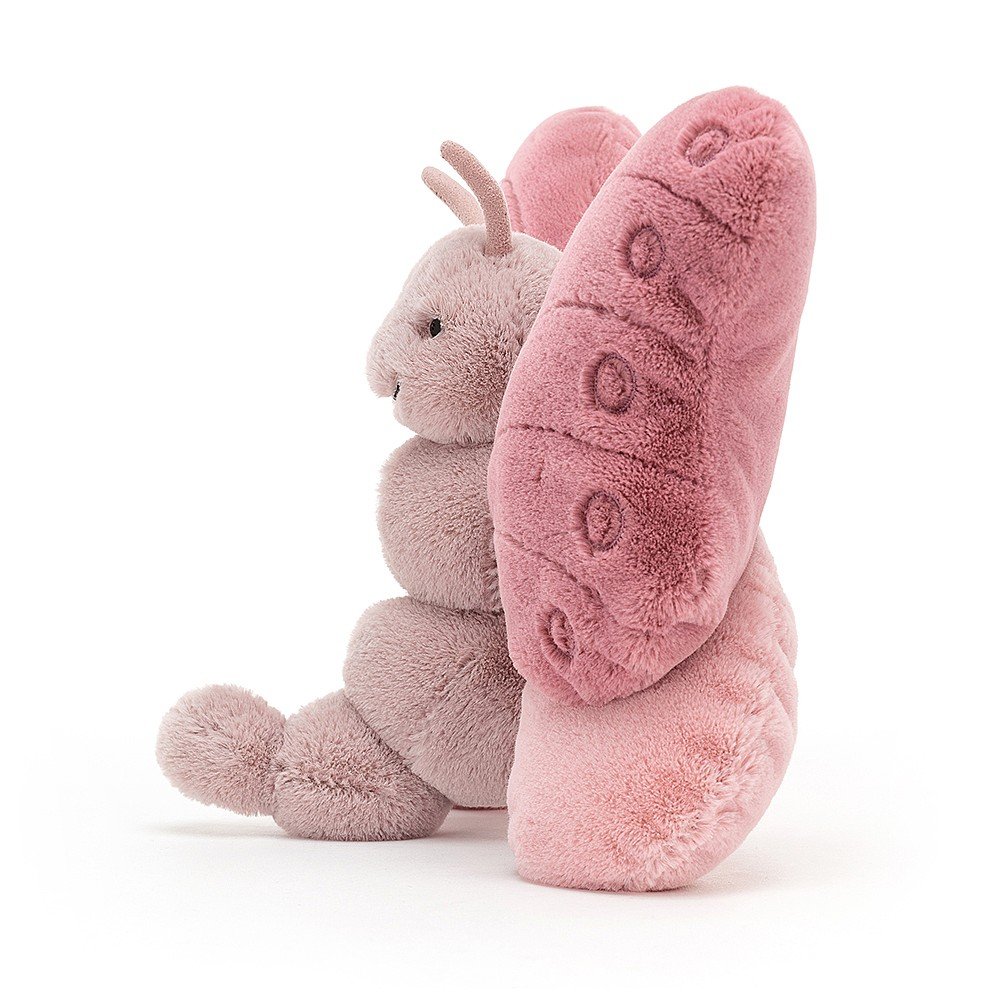 side view of beatrice butterfly plush toy on a white background