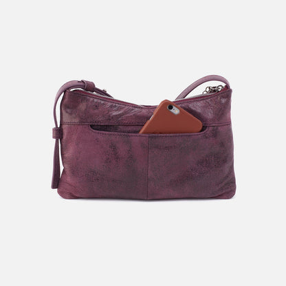 back view of the plum whipstitch paulette small crossbody with phone inside the pocket on a white background