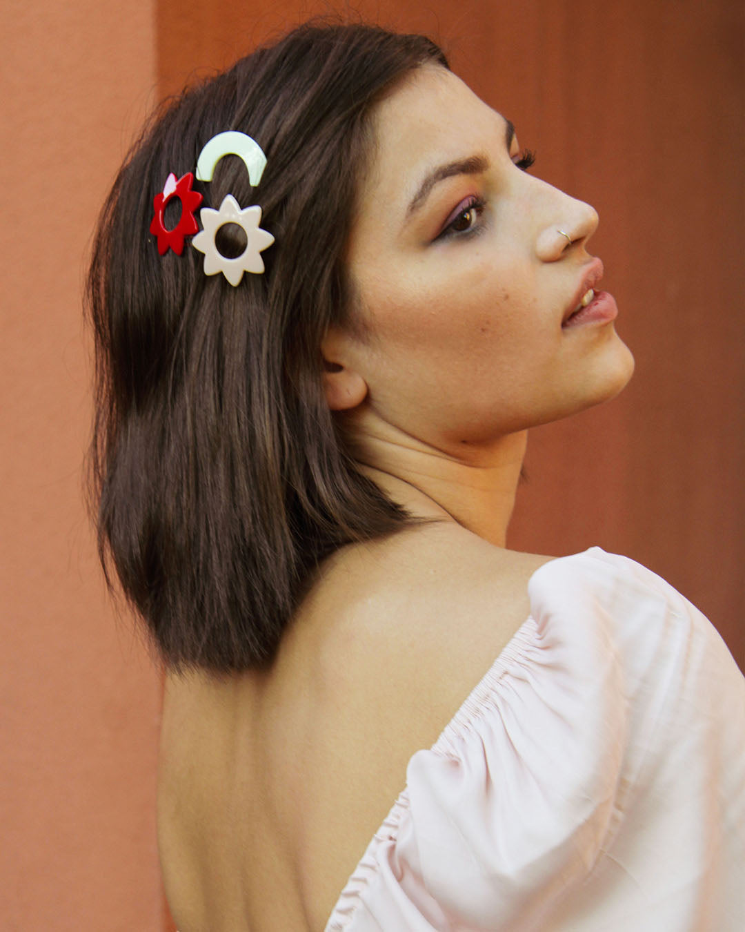 side view of a woman wearing the after the rain acrylic hair barrettes