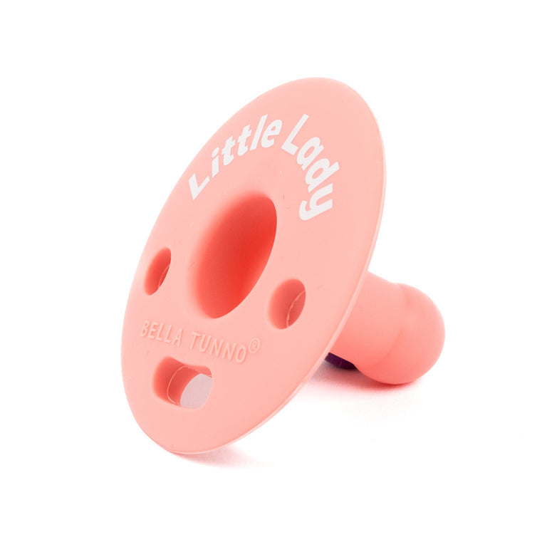 side view of the pink little lady bubbi pacifier on a white background