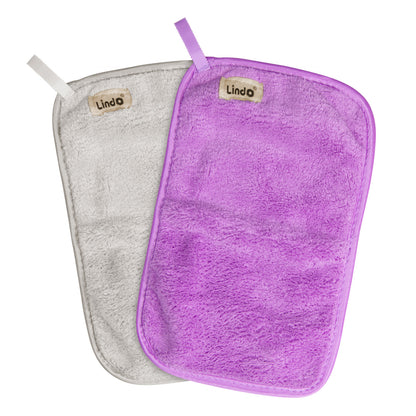 purple and ivory makeup removal beauty cloths on a white background