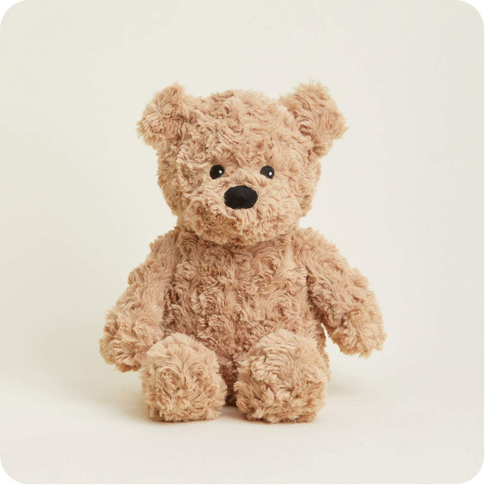 brown curly bear plush toy on a gray background