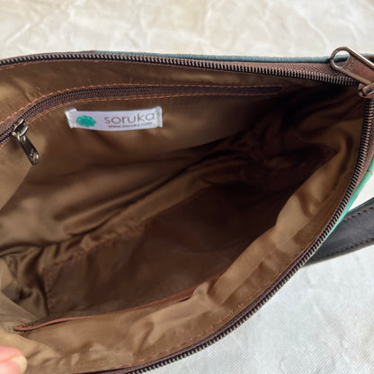 interior view of purse showing brown lining, slip pockets, and zipper pocket.