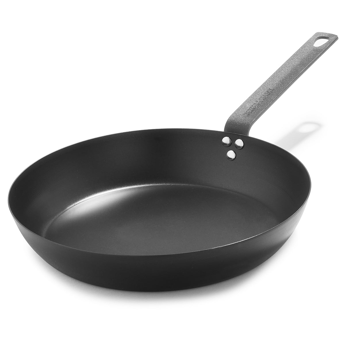 12 inch black carbon steel frypan on a white background