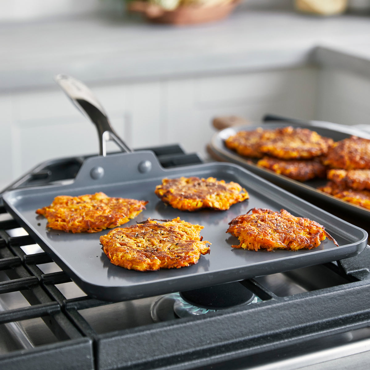 Nonstick Square Griddle on a gas range with hashbrowns on it