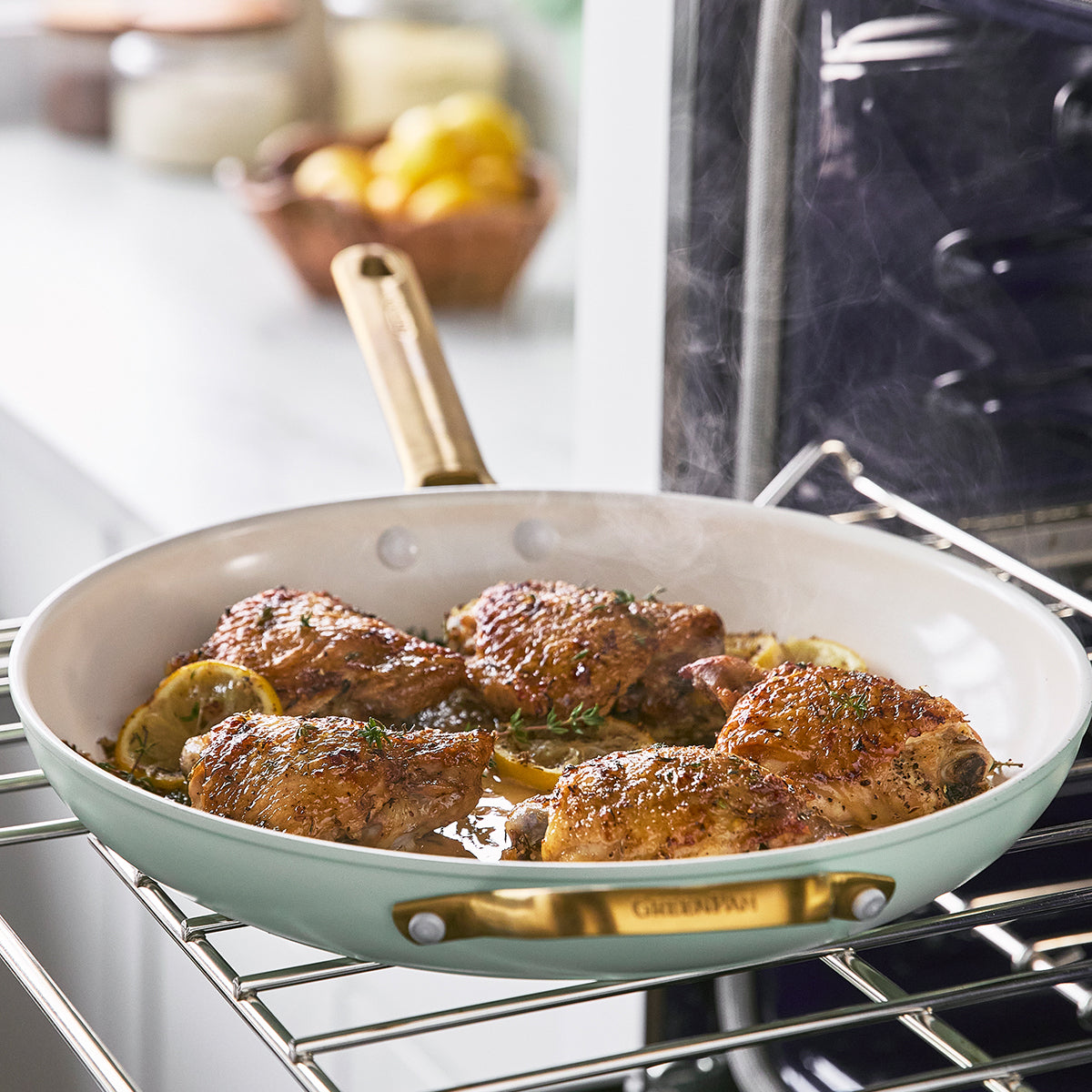 fry pan with chicken inside on oven rack.