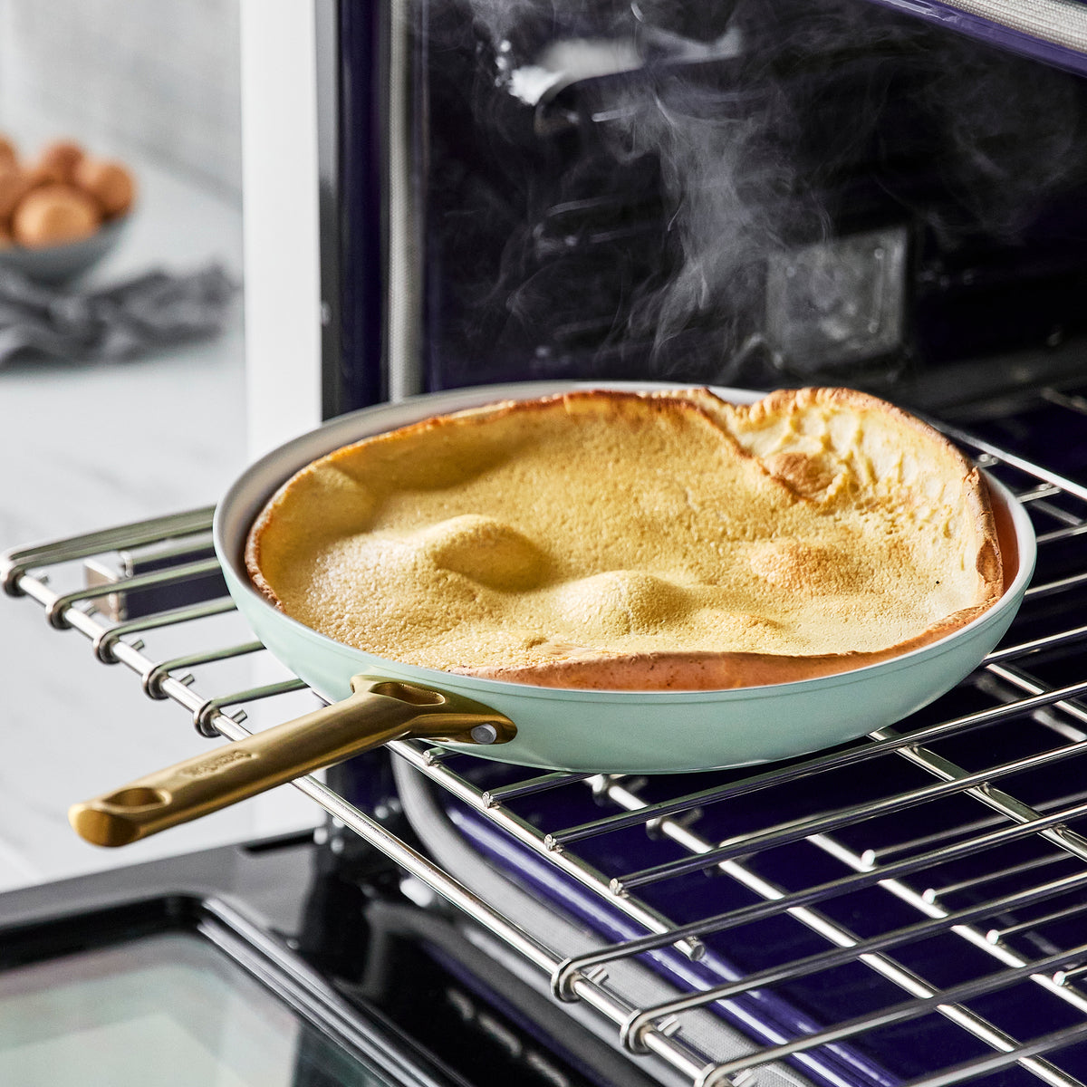 fry pan with baked goods in it on oven rack.