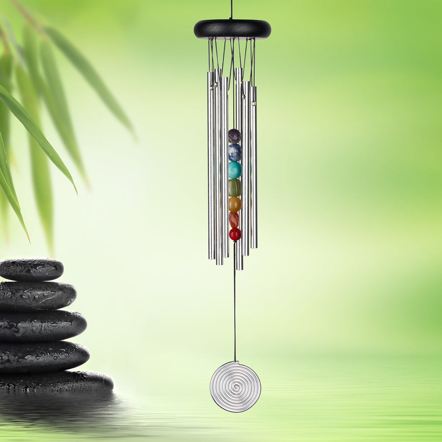 chime on green background with stack on black stones.